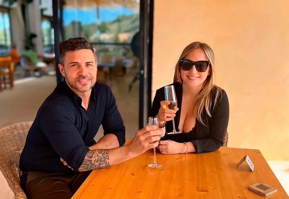 César Cano junto a su esposa brindando en una terraza