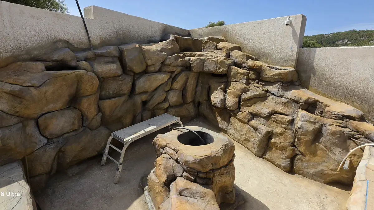 Rocas modeladas y escalones alrededor de una piscina